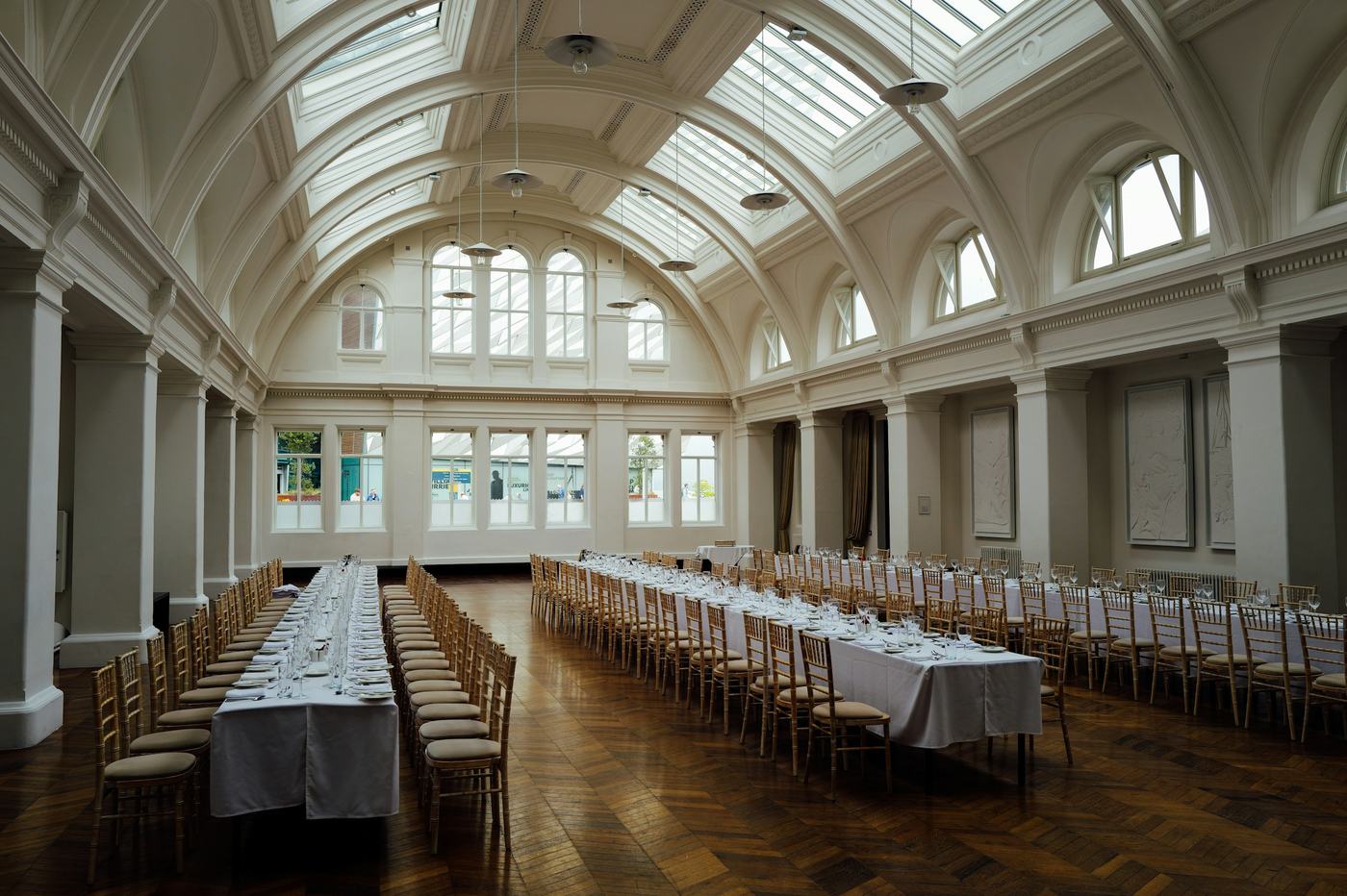 An empty banquet hall with long tables set