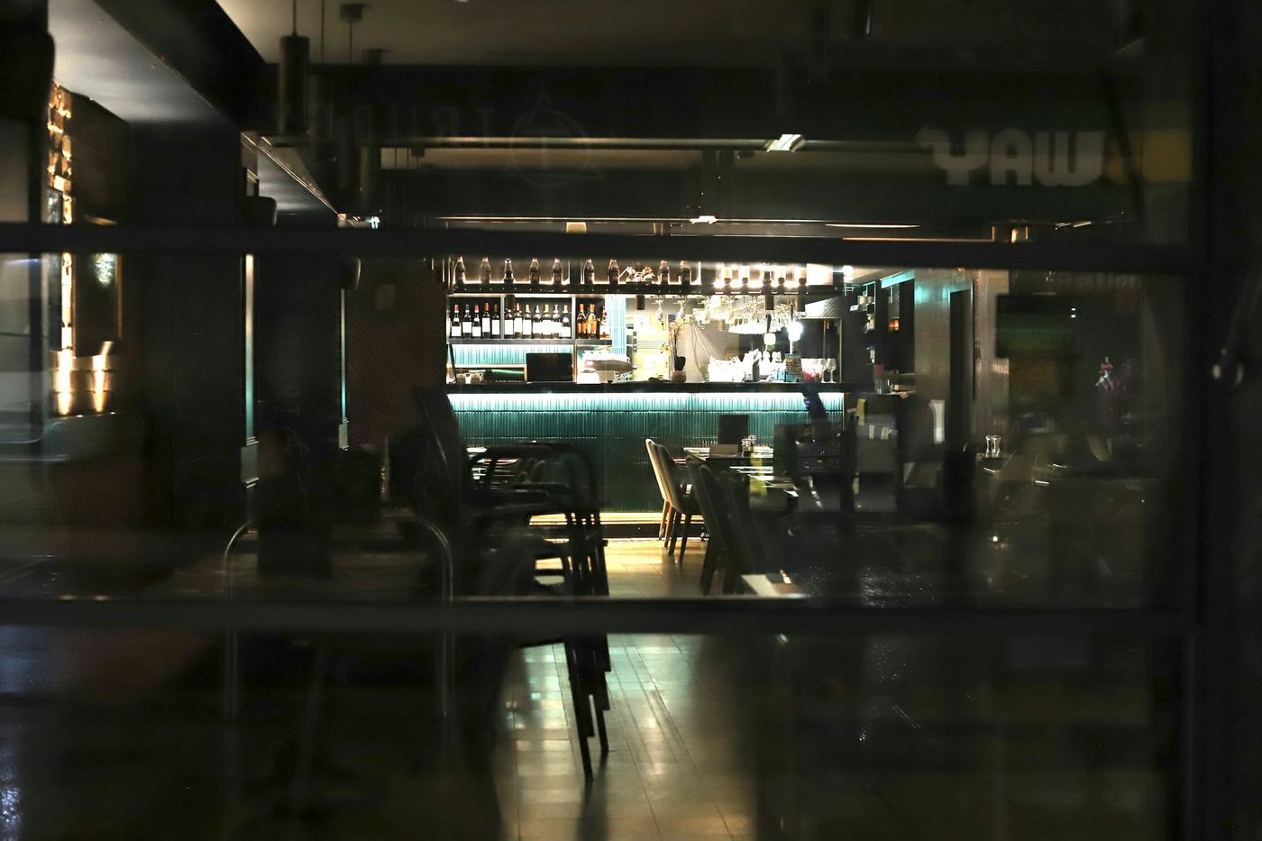 An empty bar with stools after closing time