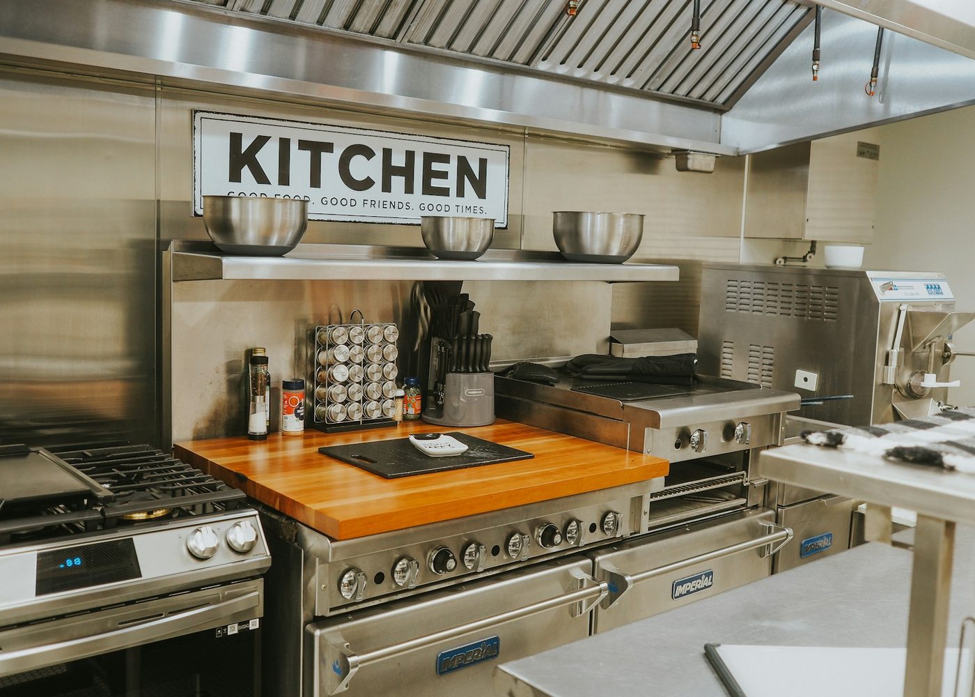 A commercial kitchen line under a KITCHEN sign