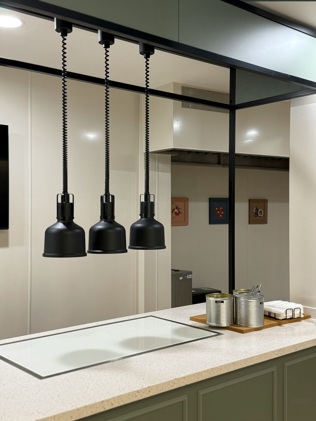 Three black heat lamps over a clean stone pass
