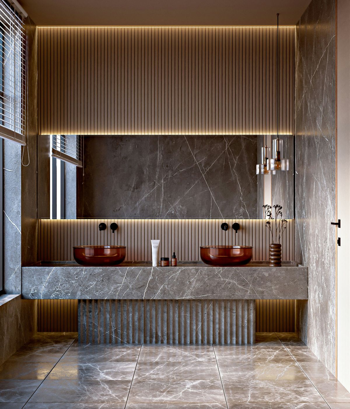 A marble restroom vanity with twin basins under warm lighting